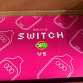 XCLUSIVE BOUTIQ X “ORB” switch with sleek black design and modern aesthetic, close-up of switch button and textured surface.